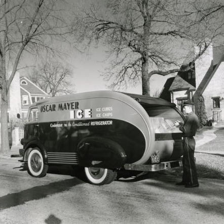 WHI Image ID #8893 A man uses tongs to remove a block of ice from the back of an International D-300 owned by the Oscar Mayer Company as he makes a delivery to 150 Lakewood blvd, Maple Bluff. The home was owned by Jack Reynoldson, an Oscar Mayer employee.